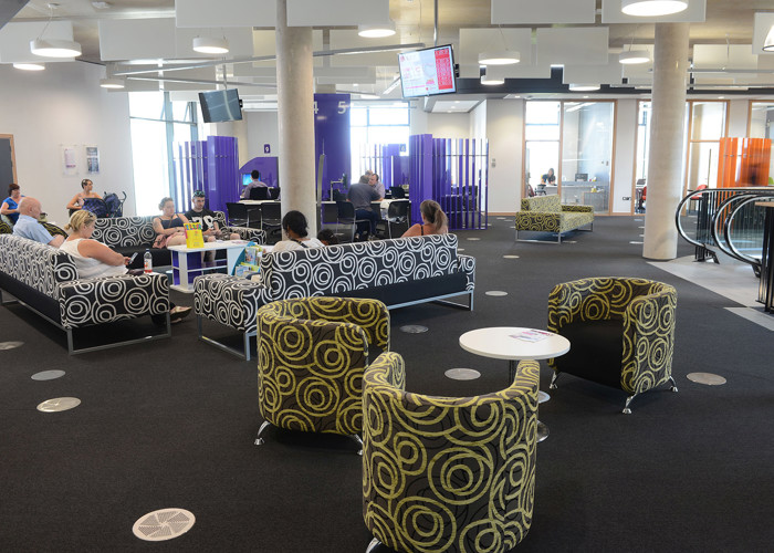 Council contact and advice library design — customer service zone with advice desks and waiting area at Southwater Library