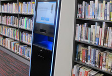 RFID self-service library design — kiosk housing with book return shelves integrated into library entrance