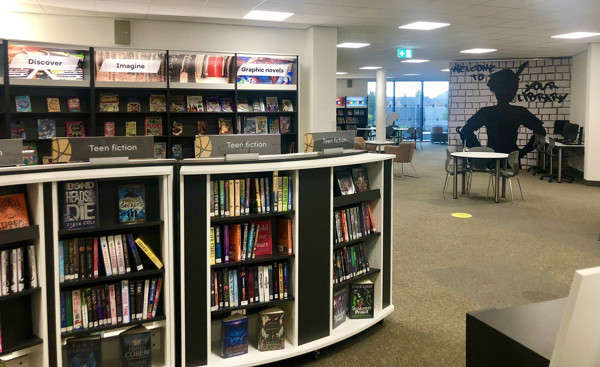 Teen fiction shelves with face-out book displays and a graphic novel section in a young readers' browsing space at Danum Library