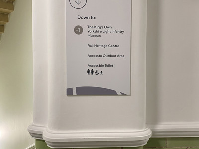 Directional sign indicating access to the Yorkshire Light Infantry Museum and outdoor area at Danum Library